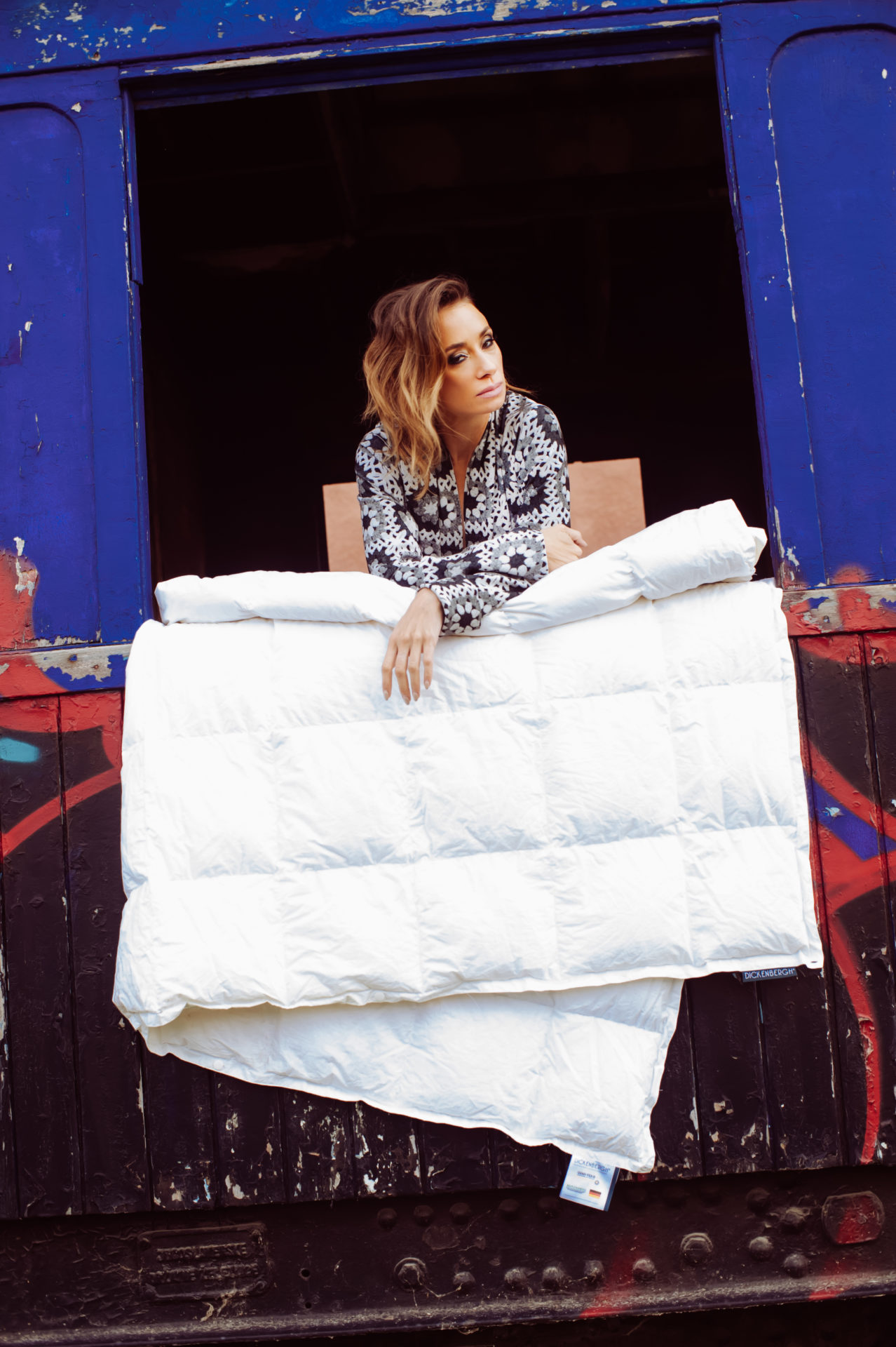 Female Model with DownDuvet leaning out of train